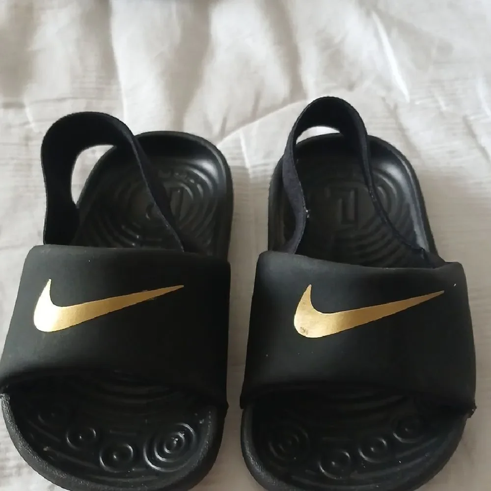 Nike Black and Gold Slide Sandals with Textured Footbed